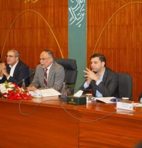 a group of men sitting at a table