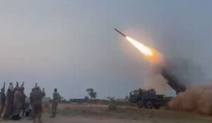 Missile launch with soldiers observing.
